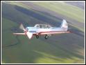 Yak-52 in turn over the field